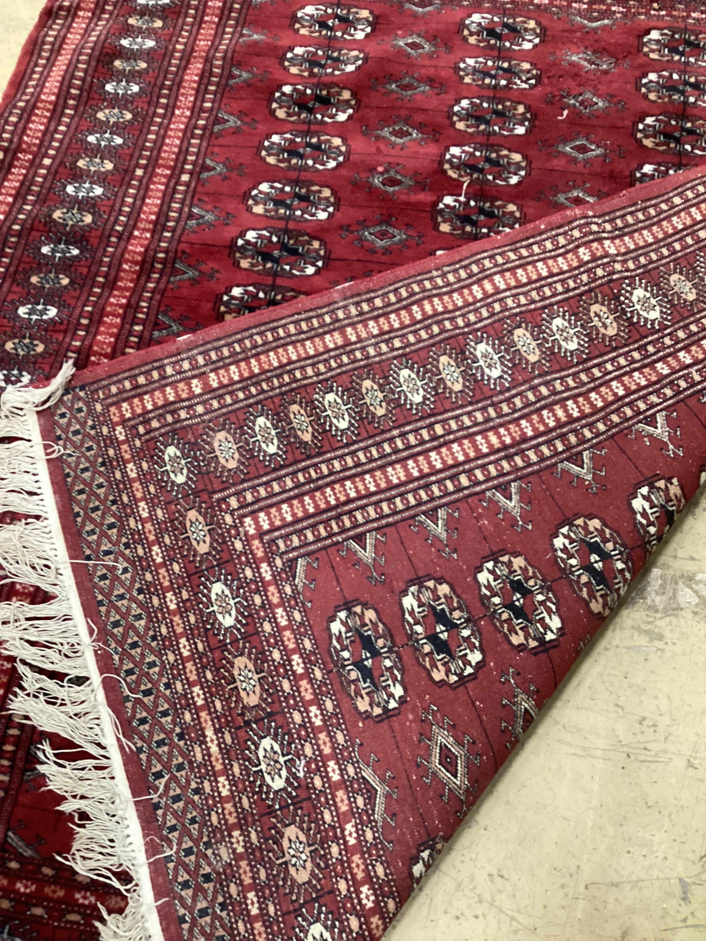 A Bokhara red ground rug, 145 x 120cm